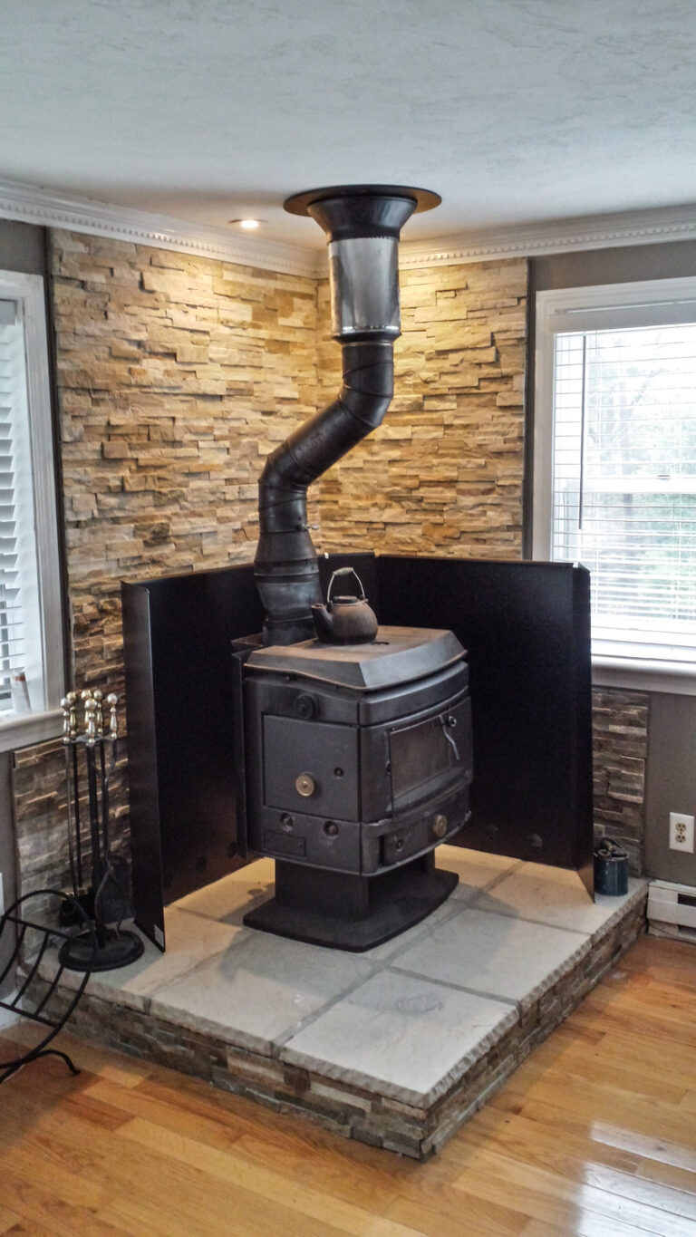 wood stove installed with heat shield